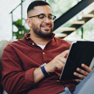 Reading,,Glasses,And,Happy,Man,Relax,With,Tablet,On,Sofa